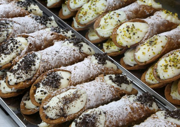 typical Sicilian cannoli stuffed with ricotta and chocolate and pistachio flakes